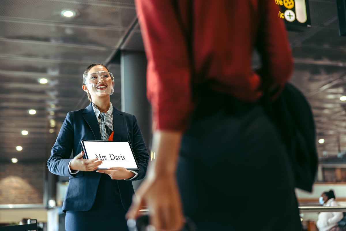 Driver greeting passenger at airport